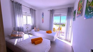 A hotel room with two beds, a balcony, and a view of the outside. - Villa Modern Princess (Golf Del Sur)