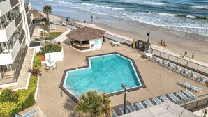 Un hotel con piscina, acceso a la playa y vista al océano.