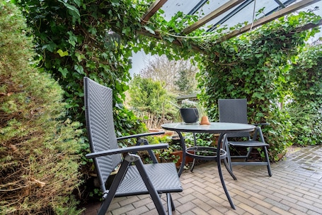 Outdoor dining. Apartment 'Ferienwohnung Mit Maritimen Flair' with Private Terrace and Wi-Fi