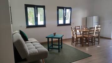 Deluxe Apartment, Garden View | Living area | TV