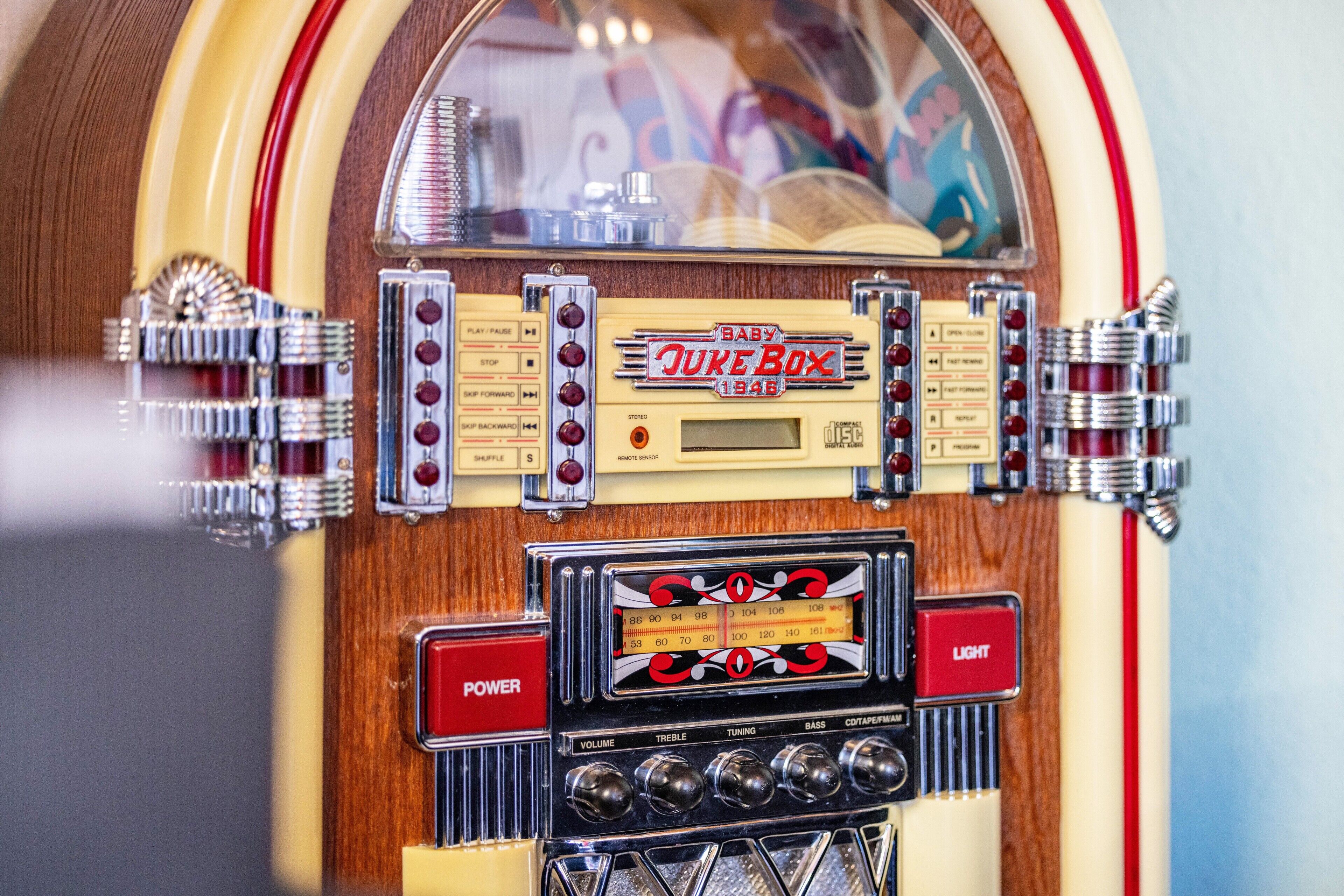 A jukebox with a wooden finish, a red 'POWER' button, and a 'Baby Juke Box' sign.