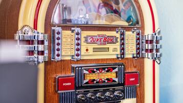 A jukebox with a wooden finish, a red 'POWER' button, and a 'Baby Juke Box' sign.