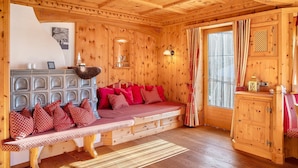 A wooden cabin interior with a bench, a cabinet, and a window with curtains. - Holiday Home 'Haus Hart Im Zillertal 6 People' with Mountain View, Terrace & Wi-Fi (Hart im Zillertal)