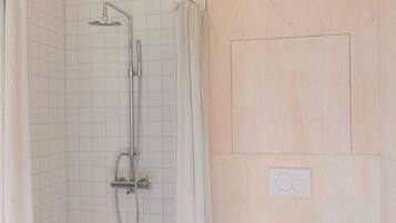 A bathroom with a shower, toilet, and a towel rack.