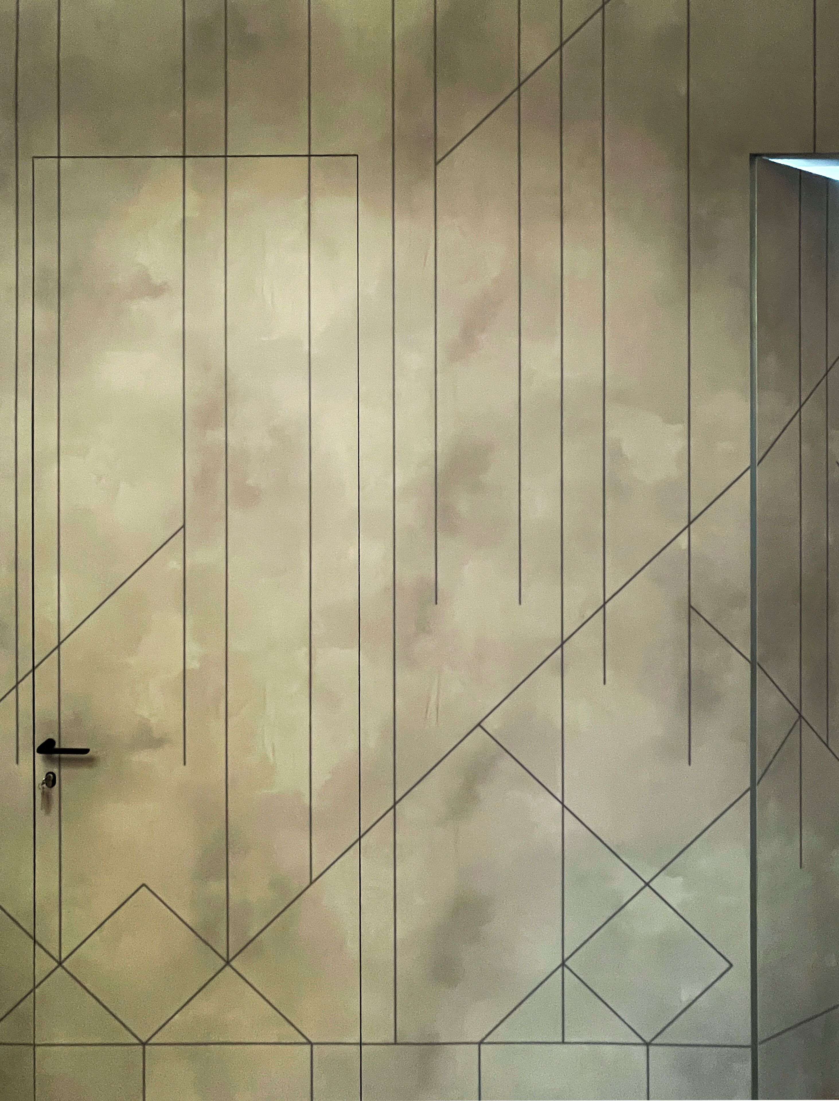 A geometric wall design with a door and a keyhole.