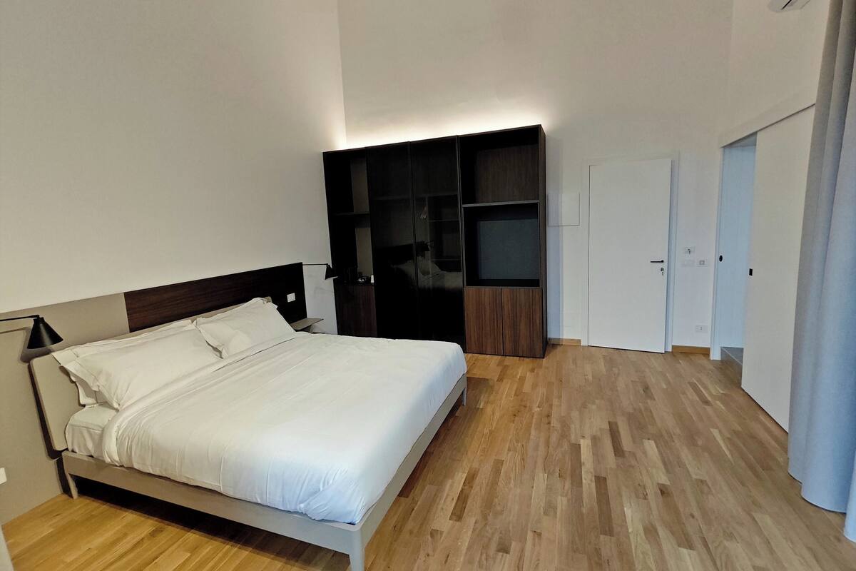 Una camera da letto con un letto, un armadio e una porta.