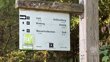 A directional signpost with multiple route options and distances.