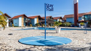 A hotel with multiple buildings, a swimming pool, and a sign that reads "Stay Fall". - 014D-Village Praia dos Carneiros III (Tamandaré)