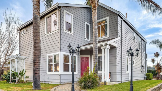 A two-story house with a red door, white trim, and a brick pathway leading to the entrance. - Napa Nearby! Large Home w/ Hot Tub & Dtwn Access (Suisun City)