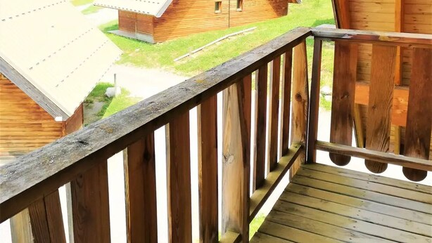 A wooden cabin with a balcony overlooking a rural landscape. - Chalet for 7 people - Les Flocons du Soleil (LE DEVOLUY)