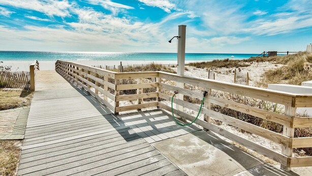 A wooden boardwalk leading to a beach with a clear sky. - Windancer 208 Gulf Front, Free Beach Service, Emerald Waters, Pool, & Grill. (Miramar Beach)