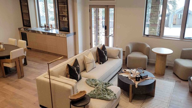 A modern living room with a sofa, chairs, a coffee table, and a dining area. - 1175 B Casolar Del Norte 3 Bedroom Duplex (Vail)