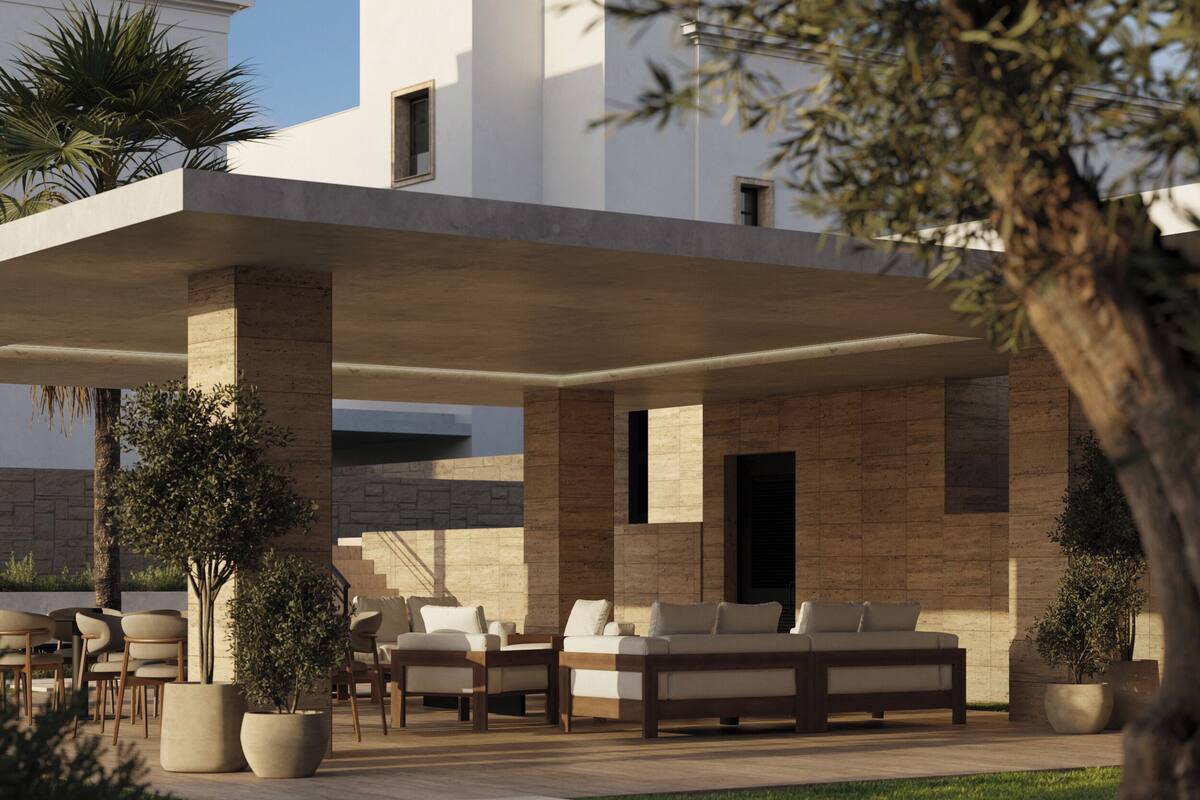Un espace de détente extérieur moderne, agrémenté d’un mur en pierre, d’une terrasse en bois et d’un grand arbre au premier plan.