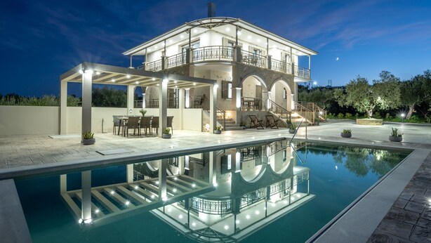 A two-story house with a swimming pool, outdoor seating, and a covered patio area. - Casa Lydia - 5 Bedrooms, Private Pool & Sea Views (Zakynthos)