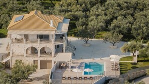 A two-story building with a pool, outdoor seating, and a garden. - Casa Lydia - 5 Bedrooms, Private Pool & Sea Views (Zakynthos)