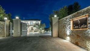 A gated entrance to a property named Casa Lydia, featuring a stone wall and a metal gate. - Casa Lydia - 5 Bedrooms, Private Pool & Sea Views (Zakynthos)