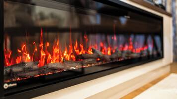 A fireplace with visible logs and flames.