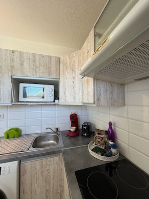 A compact kitchen with a microwave, toaster, coffee maker, and a small sink. - Studio 2OO M Centre Saint Florent -in quiet building. (Saint-Florent)