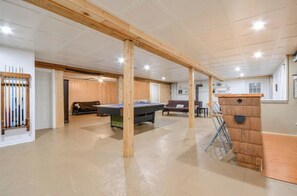 A spacious indoor area with a pool table, wooden beams, and a small play area. - Chalet Béatitude (Val-des-Bois)