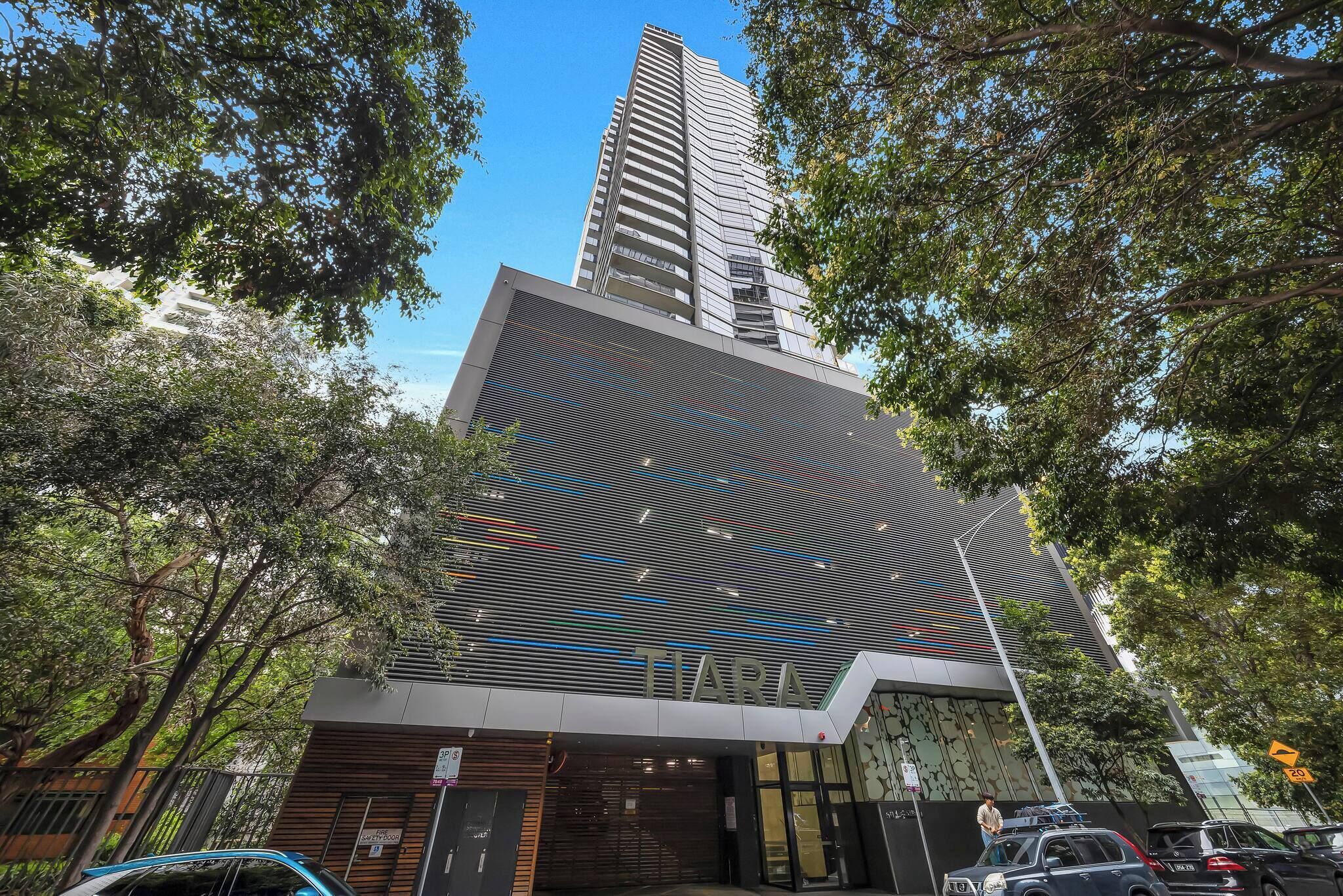 A modern building with a prominent 'TIARA' sign, surrounded by trees and featuring a sleek, contemporary design.
