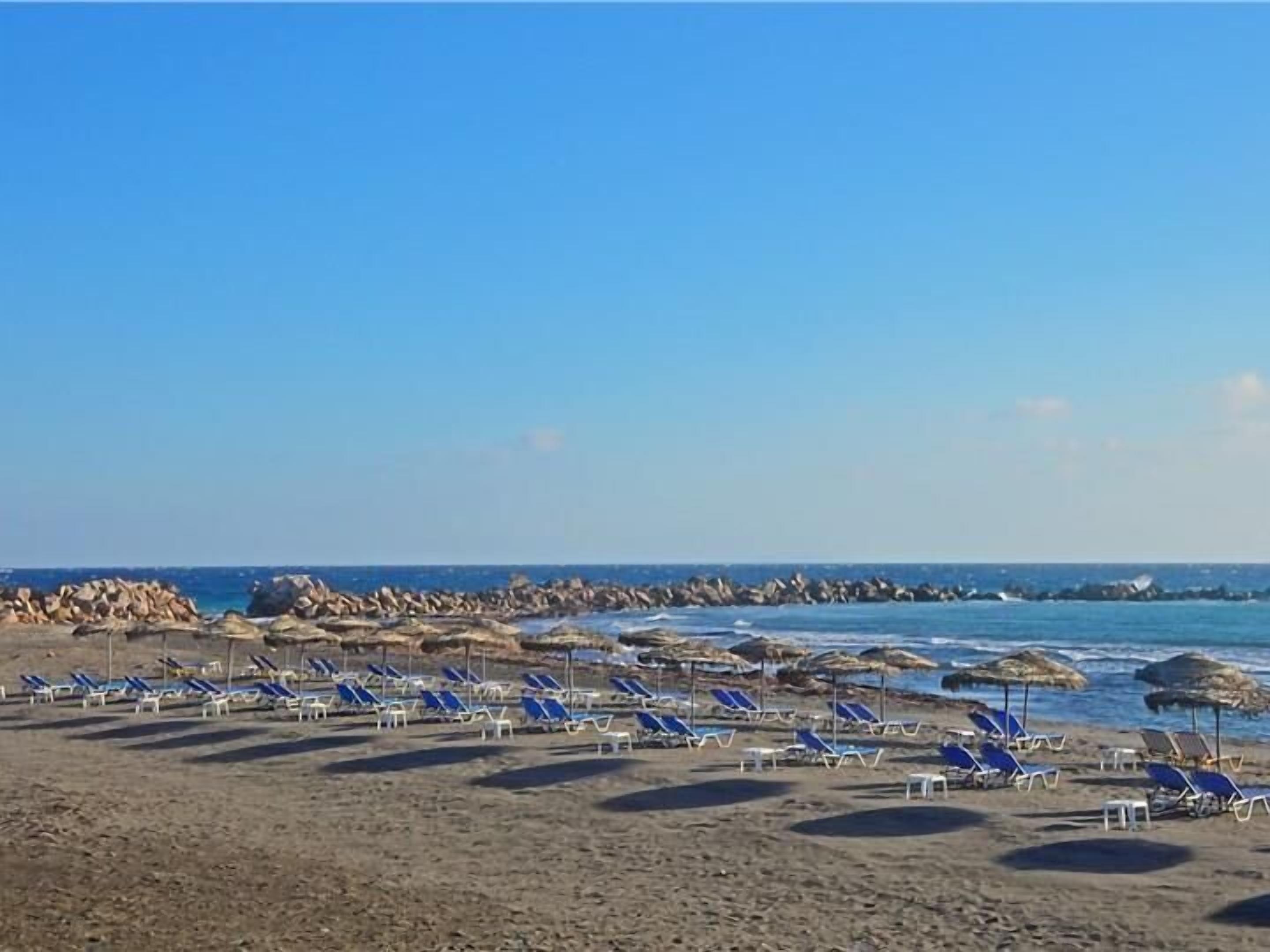 On the beach, black sand, beach towels