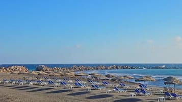 On the beach, black sand, beach towels