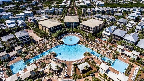 A resort with a central pool, multiple buildings, and a view of the ocean. - Seacrest "Isle Be Back" 3BR Condo, Overlooking Pool, Steps to beach! (Inlet Beach)