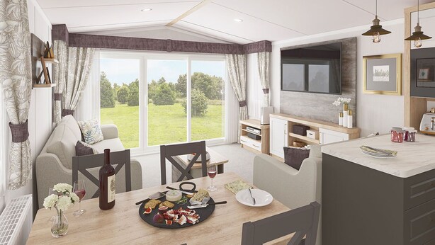 Een moderne woonkamer met een groot raam, een eethoek met een gedekte tafel, en een keuken met een televisie en kasten.