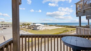 A balcony with a view of the beach and ocean. - Queen’s Court 2203 | Ocean Breeze Retreat (Emerald Isle)
