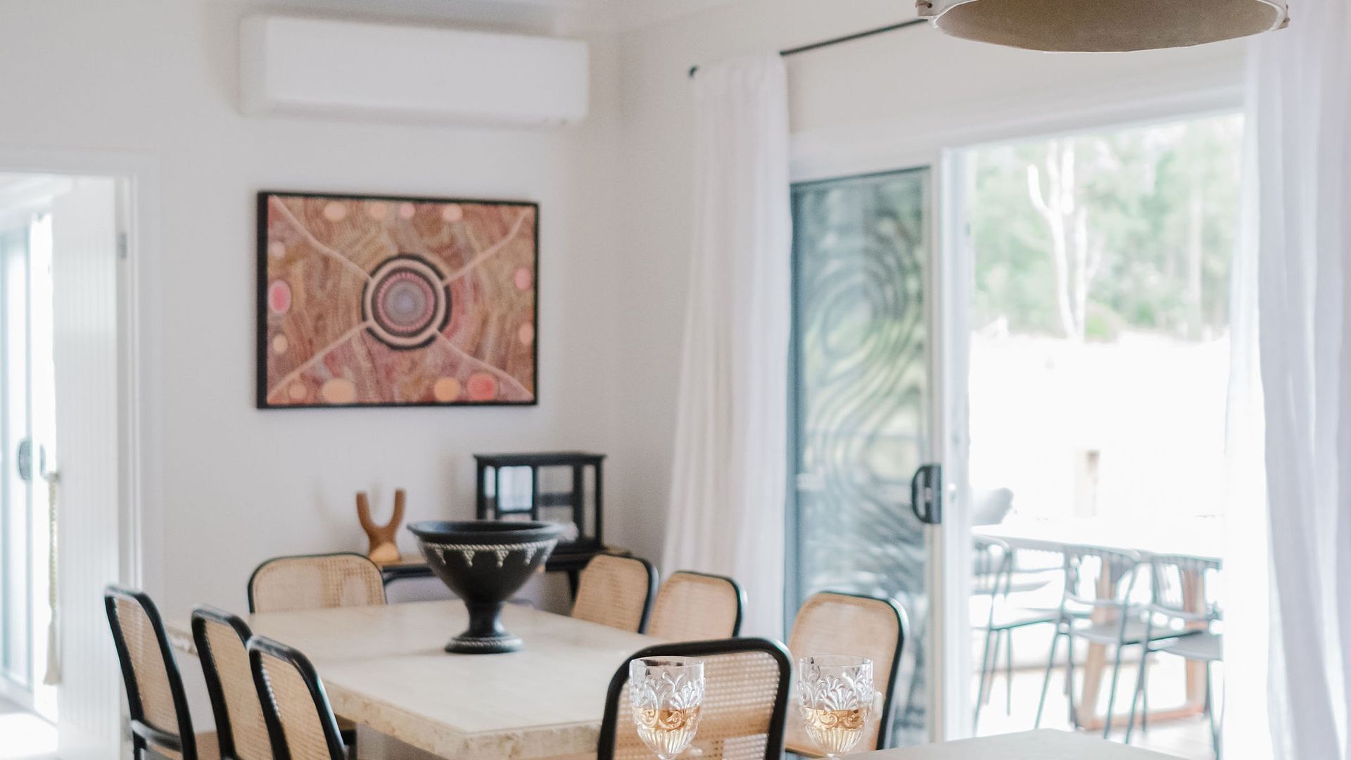 A dining area with a table, chairs, and a decorative bowl.