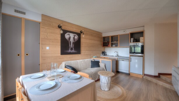 A compact kitchen with wooden cabinets, a microwave, and a small refrigerator. - Chez Arnaud - Télésiège à 200 mètres (Lélex)