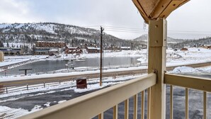 A snowy landscape with a river, buildings, and a bridge. - Alpine Getaway Steps from the Slopes (Brian Head)