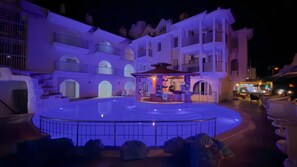 A hotel with a central courtyard, multiple balconies, and a bar area. - Rayon Apart hotel (Marmaris)