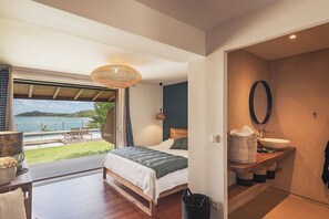 A bedroom with a large window overlooking a pool and a view of the sea. - Baltazar   Idyllic Sunrises & Stunning ocean views (Cul-de-Sac)