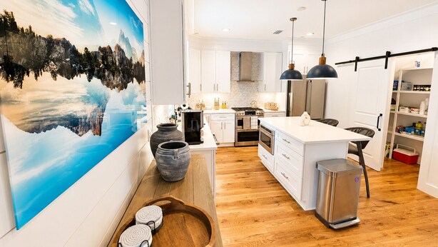 A modern kitchen with white cabinets, a wooden island, and a large painting on the wall. - Luxury 3-Level Townhome Santa Rosa Beach Florida 30A, Walk2Beach, Golf Cart,Pool (Santa Rosa Beach)