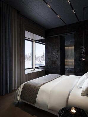Quarto moderno com cama grande, janela com vista e parede com padrão escuro.