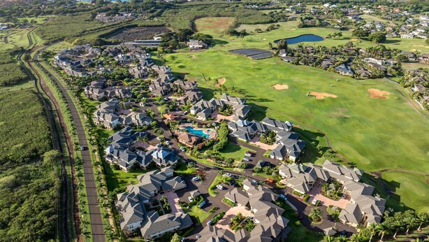 An aerial view of a residential area with houses, a golf course, and a swimming pool. - New Listing 3 Bedroom on the Golf Course in sunny Poipu (Koloa)