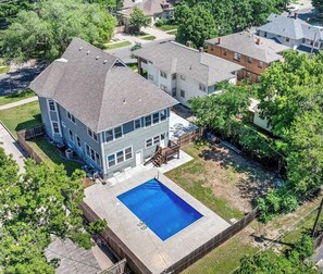 A two-story house with a swimming pool, surrounded by trees and neighboring houses. - Rocking Riverside - Pool! Hot Tub!  Sauna! Pool Table! - 5 K (Wichita)