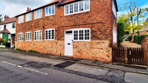A two-story brick house with a white front door and multiple windows. - Spacious & Luxury 2BR Flat in Calverton (Calverton)