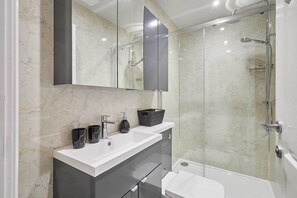 Shower, hair dryer, towels, shampoo