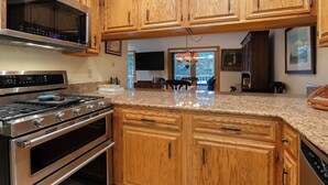 A kitchen with wooden cabinets, stainless steel appliances, and granite countertops. - I1 Gore Creek Meadows -Gorgeous Mountain Home, Private Hot Tub! (Vail)
