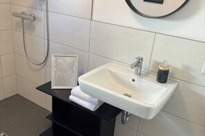 Shower, hair dryer, towels, toilet paper