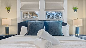 A hotel room with a large bed, two nightstands, a window with a view, and two wall-mounted planters. - East Austin Charmer│Grill, Fenced Yard & Patio│Near Rainey, UT & 6th St (Austin)
