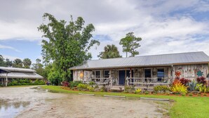 A rustic building with a porch and a sign that reads "COUNTRY HOME". - Private Lake Access, Enjoy Serenity @ Bunk South (Palm City)