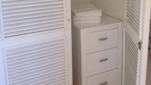 A white walk-in closet with three drawers and a hanging rod. - Comfortable Beach Living in a Mexican village! (Chelem)