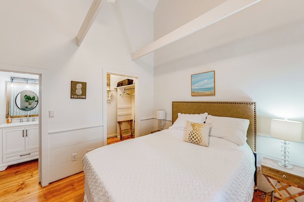 A bedroom with a large bed, a wardrobe, a mirror, and a painting on the wall. - Cozy Blue Ridge Cottage, Close to Hiking! (Landrum)