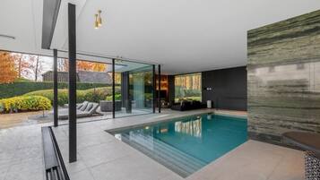 Indoor pool, open 5:00 PM to 10:00 PM, pool umbrellas, sun loungers