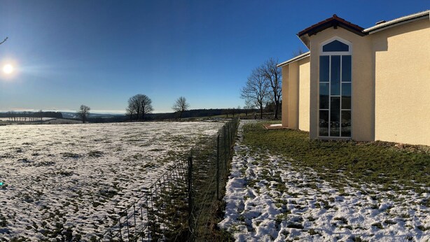 A building with a modern architectural style, featuring a prominent glass facade and a symmetrical design. - Group and stopover gîte in the heart of nature, on the Chemin de St Jacques GR65-GR7 (Riotord)