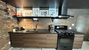 A modern kitchen with a built-in stove, a coffee maker, and a sink. - Prospect Park Escape (Brooklyn)