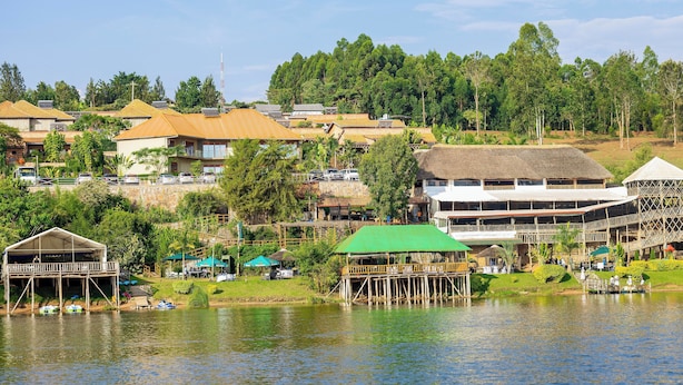 A lakeside resort with multiple buildings, a dock, and a green-roofed pavilion.